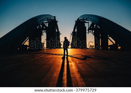silhouette of young man standing at the bridge in Kiev, Ukraine