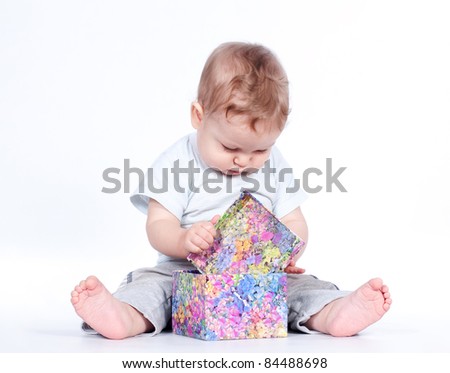 baby boy opening gift box on white background