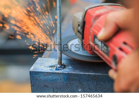 The worker cut steel and Worker cutting metal with grinder. Sparks while grinding iron