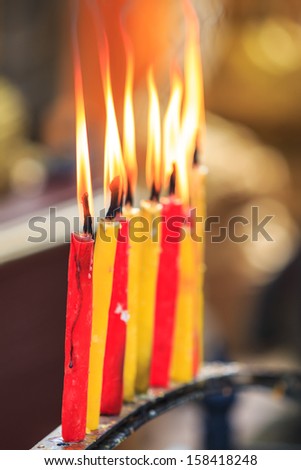 lighting prayer candle  offering, sacrificial or memorial candles lit in a church