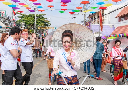 CHIANG MAI, THAILAND-JANUARY 19 : 31th anniversary Bosang umbrella festival,Women in traditional costume during the annual Umbrella festival at San Kampaeng. on Jan.19, 2014 in Chiang Mai, Thailand.