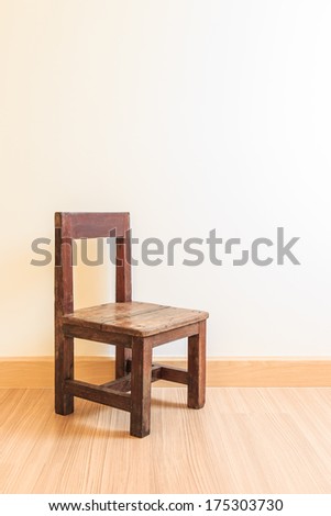 Old wooden chair on laminate flooring in the room