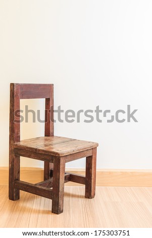 Old wooden chair on laminate flooring in the room