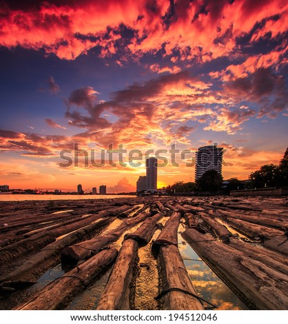 View sunset landscape at Pile of wood be immersed in water at the Bangkok Asia Thailand