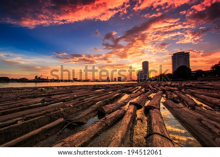View sunset landscape at Pile of wood be immersed in water at the Bangkok Asia Thailand
