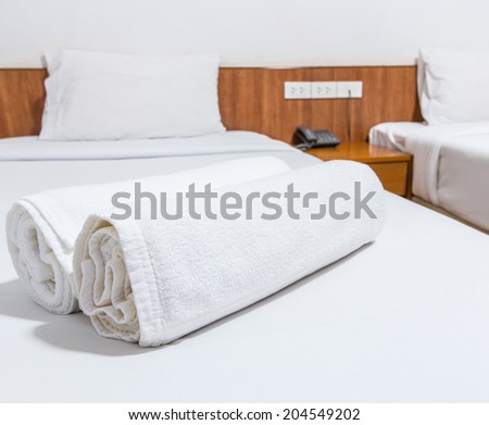 White bed and towels on the bed