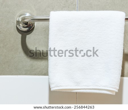 Bathroom Towel -  white towel on a hanger prepared to use
