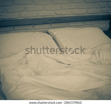 Messy and  unmade bed and Pillows on the bed