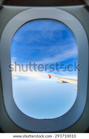 Scenery clouds and sky as seen through window of an aircraft