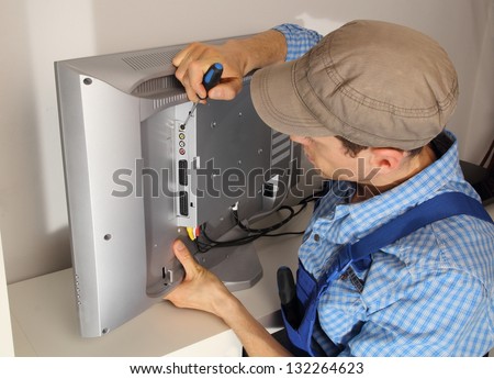 Electrician repairing a TV