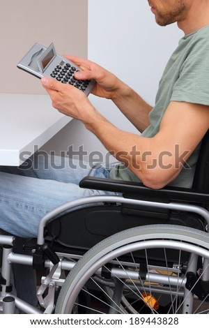 A Wheelchair user with calculator