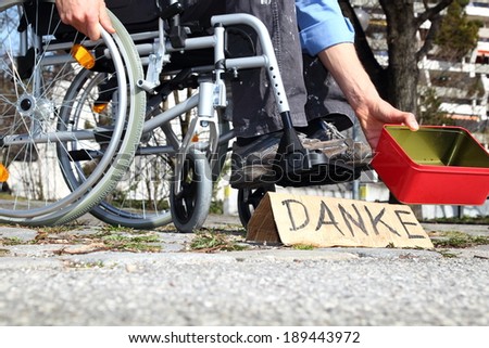 A Homeless wheelchair user asking for money