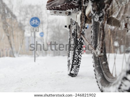 Riding a bicycle in Winter over snow