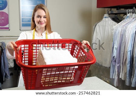 An Employee of a dry cleaning with a  laundry basket
