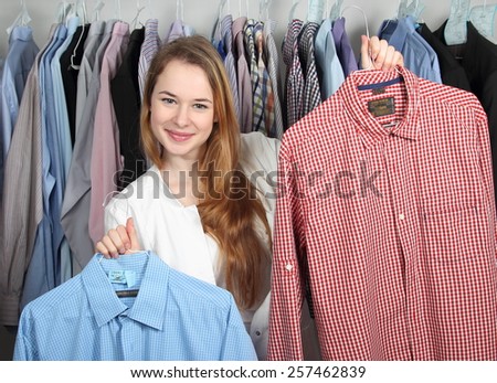 A Employee of a dry cleaning presenting two clean shirts