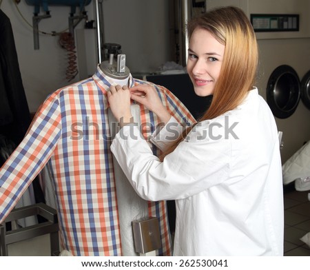 A Woman in a dry cleaning on Ironing doll machine