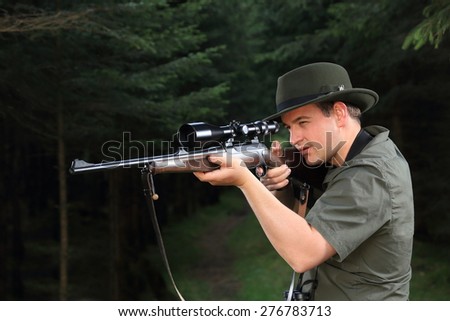 A Hunter shooting with his rifle