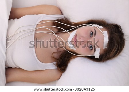 A Young woman measuring brainwaves eg in a Sleep Laboratory