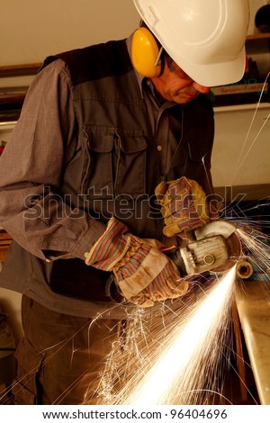 Worker with angle grinder