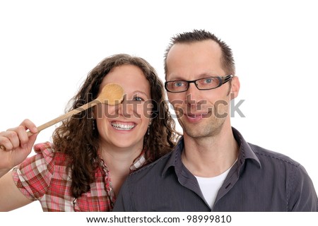 Couple with  wooden spoon in front of her eye