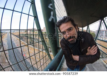 Man looking at camera in bridge over the rail train