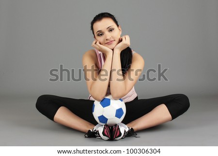 pretty girl sitting on the floor with a Ball
