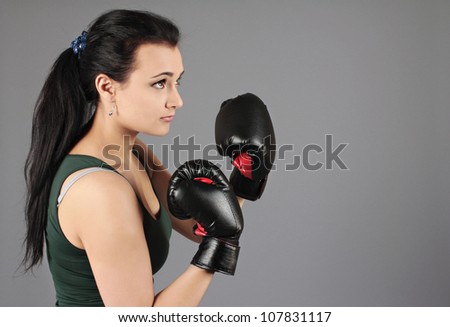 Young fitness girl, woman with boxing gloves