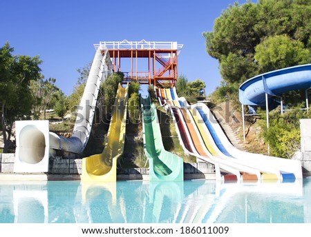Colorful water slide in water park. Bright aqua park constructions in swimming pool