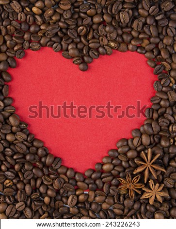 Red paper heart and star anise on background of coffee beans. Texture of roasted coffee bean with red heart for background. Valentine\'s day, wedding, love