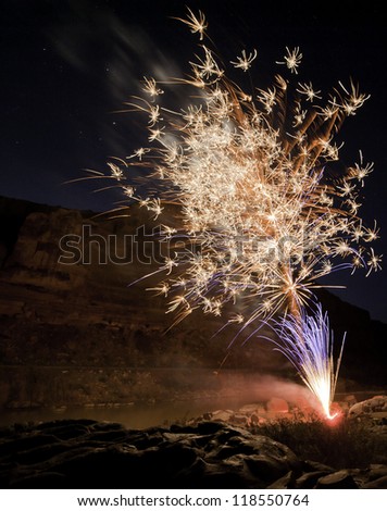 Fireworks exploding with canyon wall as background