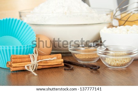 Flour, cottage cheese, egg, spices and a cake pan on a table