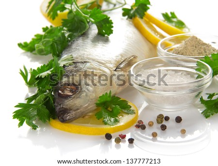Big herring with a lemon and the spices isolated on white