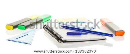 Color felt-tip pens, exercise book and the ballpoint, isolated on white