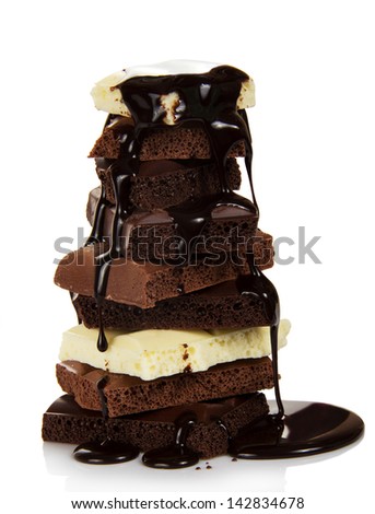Chocolate slices are watered with the hot melted chocolate, isolated on white