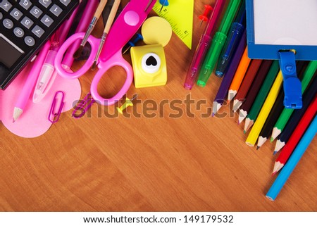 Big set of office tools, a color pencils and empty badge on a table
