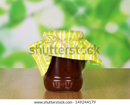 Glass jar of jam, on a table