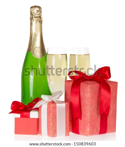 Three gift box with a tape and bow, bottle of champagne and the wine glasses isolated on white