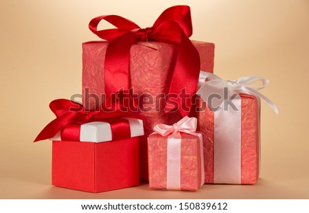 Set of gift boxes of various forms and coloring on a beige background