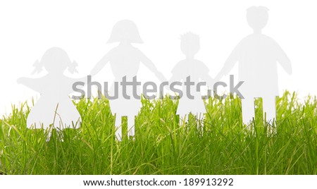 Paper Family silhouettes in grass isolated on white