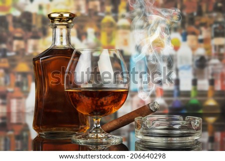 Whisky in glasses and smoking cigar