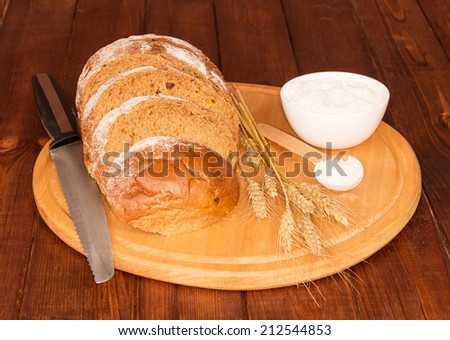 Bread and ears of wheat , knife and cream