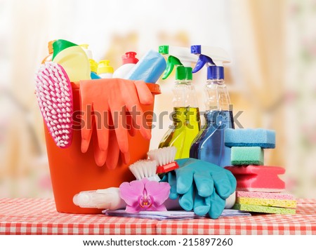 Cleaning products on table and kitchen background Cleaning products on table and kitchen background