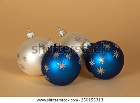 Charming Christmas spheres with silver asterisks on a beige background