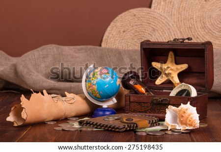 Old compass, money and Things for travel on wooden table