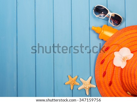 Items for relaxing on beach on blue wooden backgound
