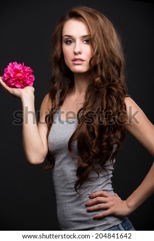 Portrait of a girl in a gray shirt with flower