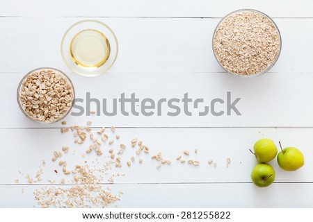 White, wooden table top view. On the table lay dietary foods for cooking healthy breakfast.Proper, balanced nutrition.
