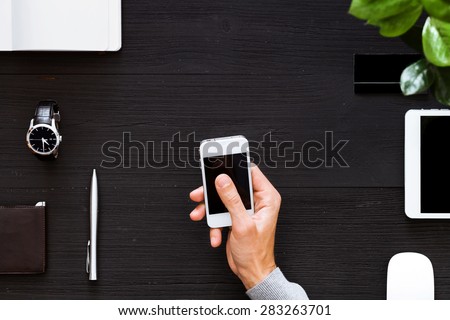 Blank modern digital tablet on a wooden desk. Top view. Great for your copy space. Gadgets on a wooden desk background. View from above.