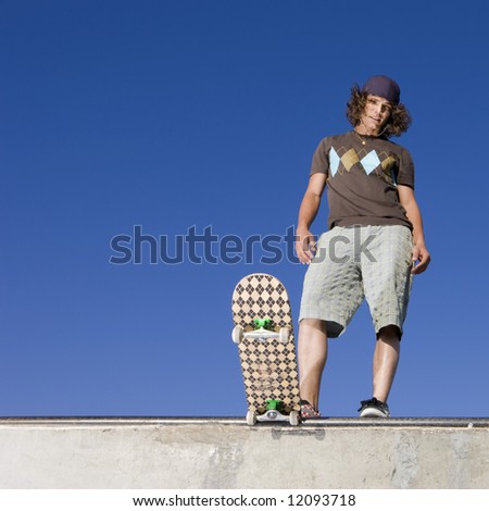 Skateboarder at top of half pipe