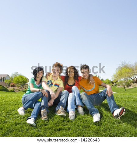 Four teens hang out in a park